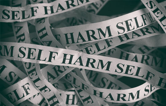 paper with the words self harm repeated
